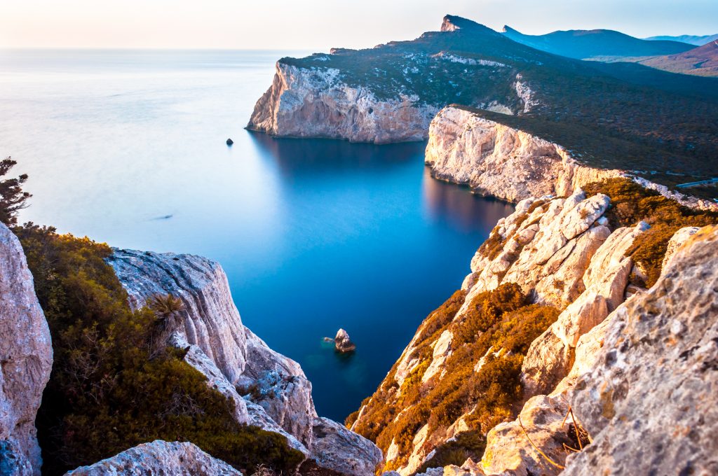 Landscape of the gulf of capo caccia from the Cave of broken vessels at sunset